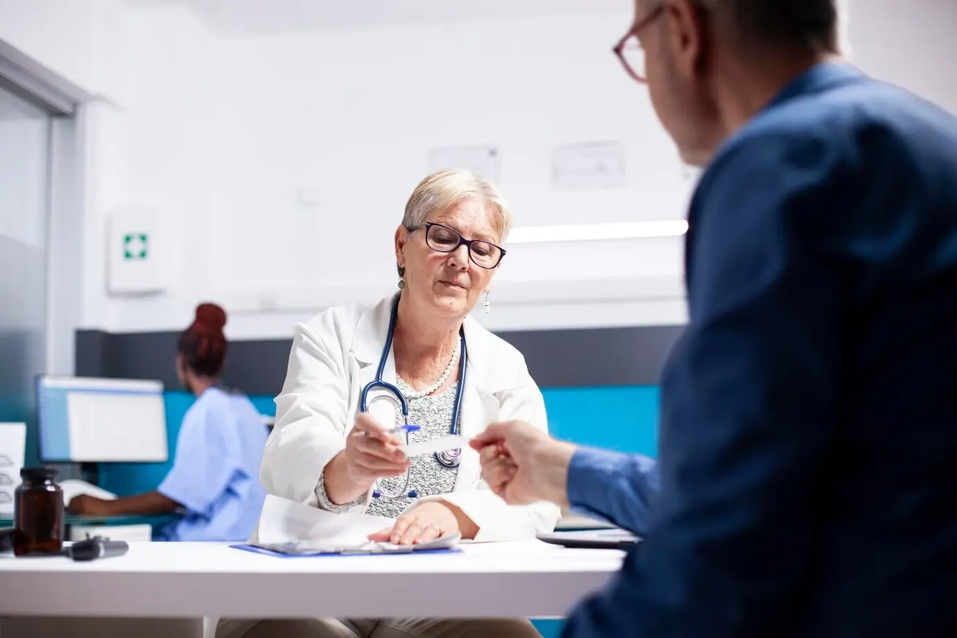 A doctor gives a medical document to a patient.